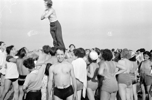 Reginald Marsh, [Woman performing stunt on Coney Island beach.], ca. 1938, Museum of the City of New York. © 2012 Estate of Reginald Marsh / Art Students League, New York / Artists Rights Society (ARS), New York