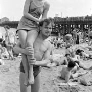 Reginald Marsh, [Man carrying woman on shoulders at Coney Island beach.], ca. 1938, Museum of the City of New York. © 2012 Estate of Reginald Marsh / Art Students League, New York / Artists Rights Society (ARS), New York