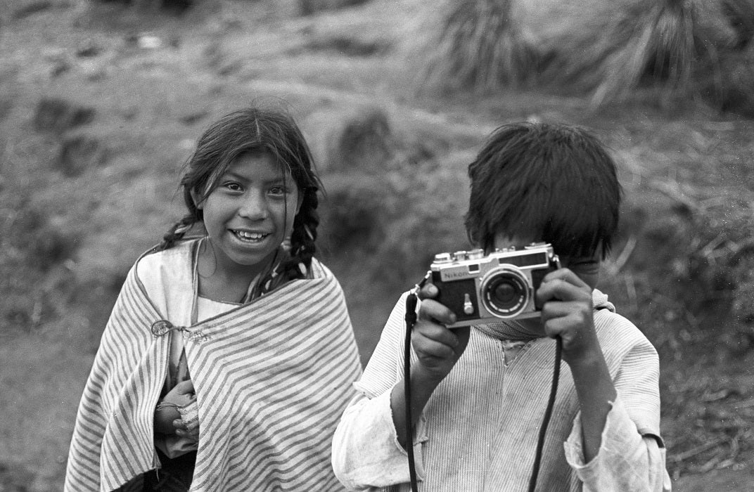 Frank Cancian. Shooting back, Juan Vásquez (Pig) family (Another Place). 1971. Black-and-white photograph. © Frank Cancian. Image and data provided by University of California Irvine Libraries.
