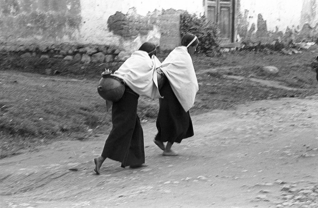 Frank Cancian. Women carrying water in the street (Another Place). 1971. Black-and-white photograph. © 2001 Frank Cancian. Image and data provided by University of California Irvine Libraries.