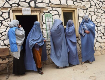 Jeroen Oerlemans. Women queue to cast their vote at a polling station that is exclusively for women, in the small village of Jabal-o Saraj. 2004.