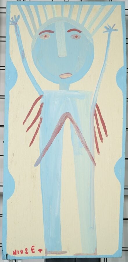 Painting of a light-blue human figure that is almost entirely legs and head, with thin arms stretched overhead and bright red streaks below the arms and across the torso. Blue rays of light emanate from the figure's head.