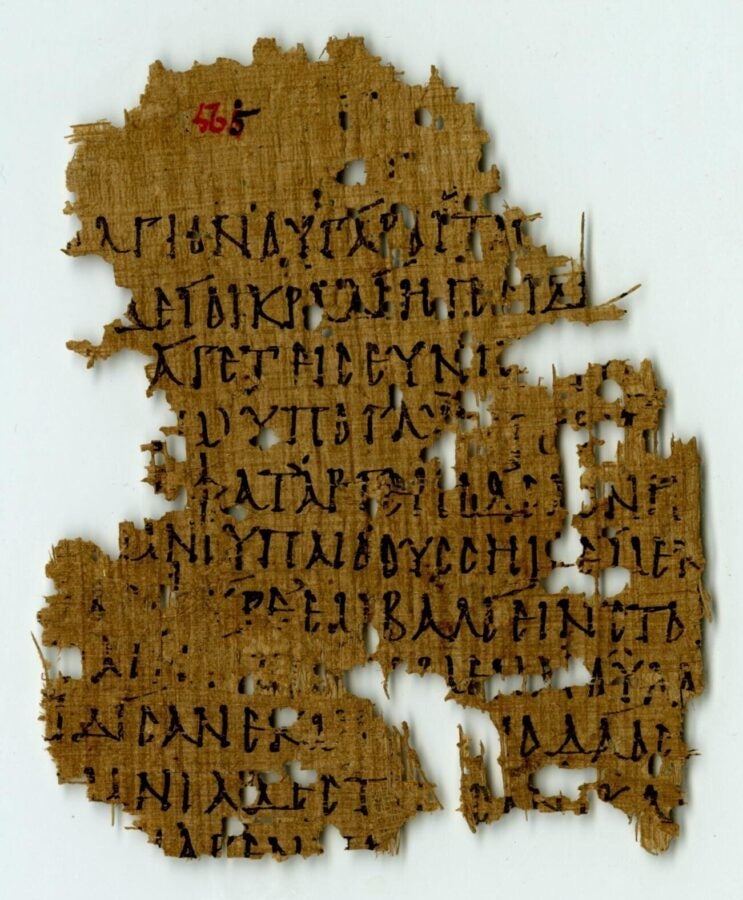 Fragment of ancient Greek text on papyrus, brown and torn with missing sections.