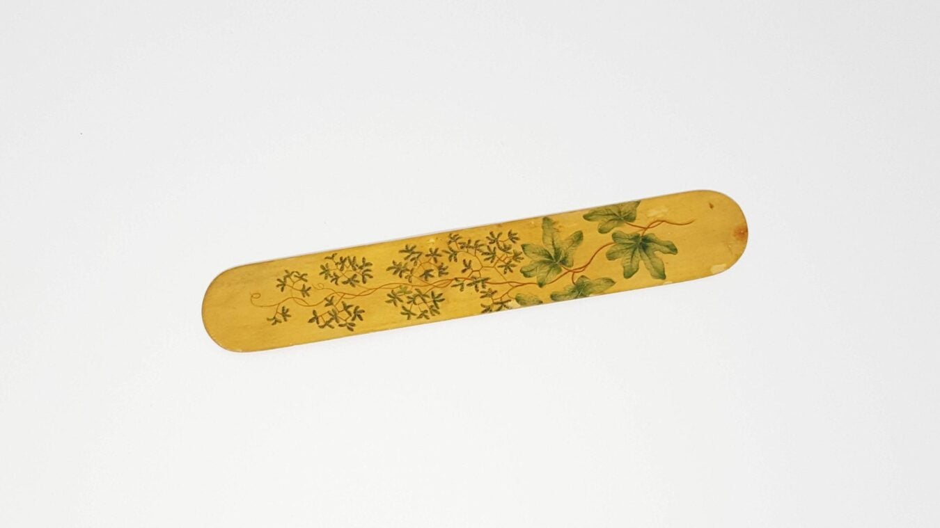 Hand-painted wooden paper cutter featuring floral designs.