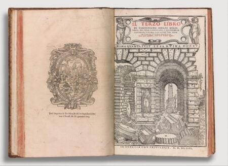 An open Renaissance-era book featuring architectural illustrations and decorative typography. The right page displays the title Il Terzo Libro by Sebastiano Serlio, with an elaborate engraving of Roman ruins, including arches, statues, and scattered architectural fragments. The left page contains a detailed emblem with Latin inscriptions, framed by intricate ornamentation.