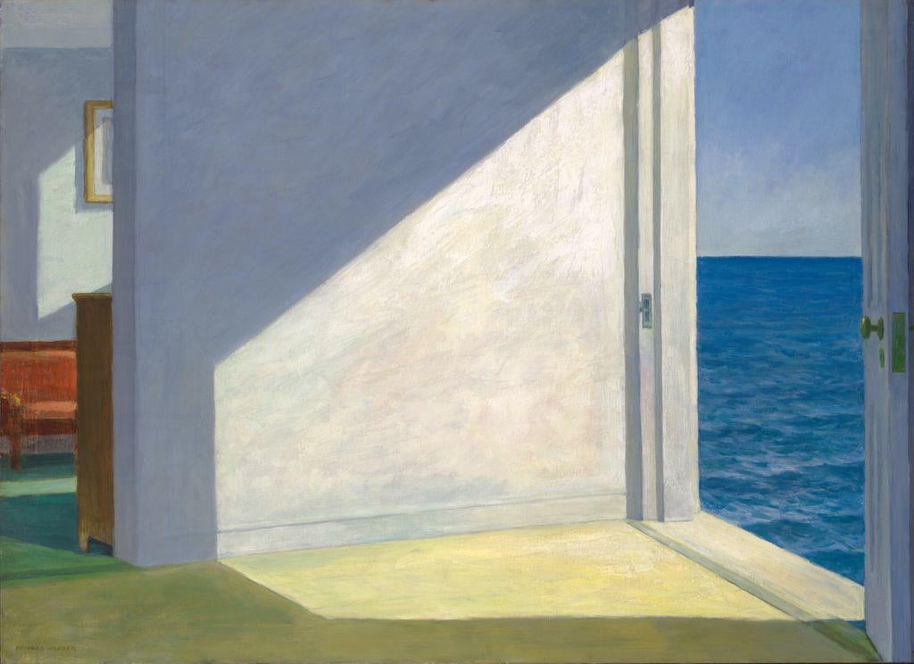 A painting by Edward Hopper titled Rooms by the Sea (1951) depicts a sunlit interior with an open door leading directly to the ocean. The composition features geometric shapes, sharp contrasts of light and shadow, and a tranquil color palette of blues, whites, and warm yellows. Inside, a partial view of a red sofa and a framed picture on the wall hint at habitation, while the open doorway creates an ambiguous and almost surreal sense of space and solitude.