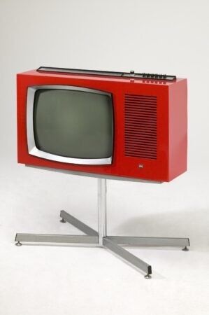 A red, black and white television in 1960's style
