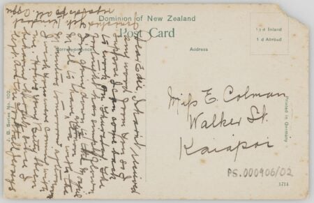 A vintage postcard from the Dominion of New Zealand, addressed to "Miss E. Colman, Walker St., Kaiapoi." The card features handwritten cursive text filling the left half and part of the top margin, written in black ink. Printed text includes "Post Card," "Printed in Germany," and postage rates: "1½ d Inland, 1 d Abroad." A corner of the postcard is torn, and the card is slightly yellowed with age.