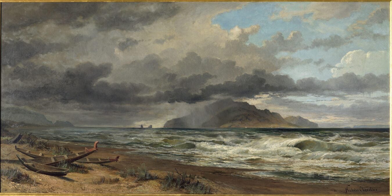 A dramatic seascape by Nicholas Chevalier showing storm clouds over Cook Strait, New Zealand. The waves are crashing against a sandy shore where two Māori-style wooden canoes rest abandoned. Distant rain veils an island under a burst of sunlight breaking through the clouds.
