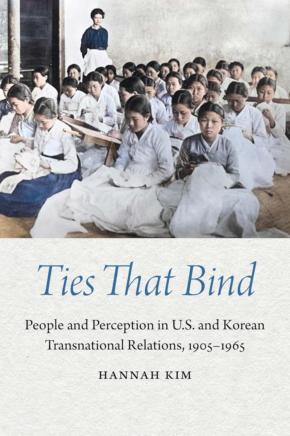 Cover of ‘Ties That Bind’: colorized classroom photo of Korean schoolgirls sewing with a Western teacher; blue script title on cream.