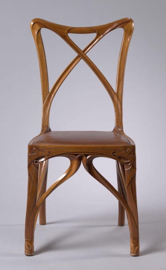 Curved wooden side chair with an interlaced, sculptural back and organic, flowing lines characteristic of Art Nouveau design.