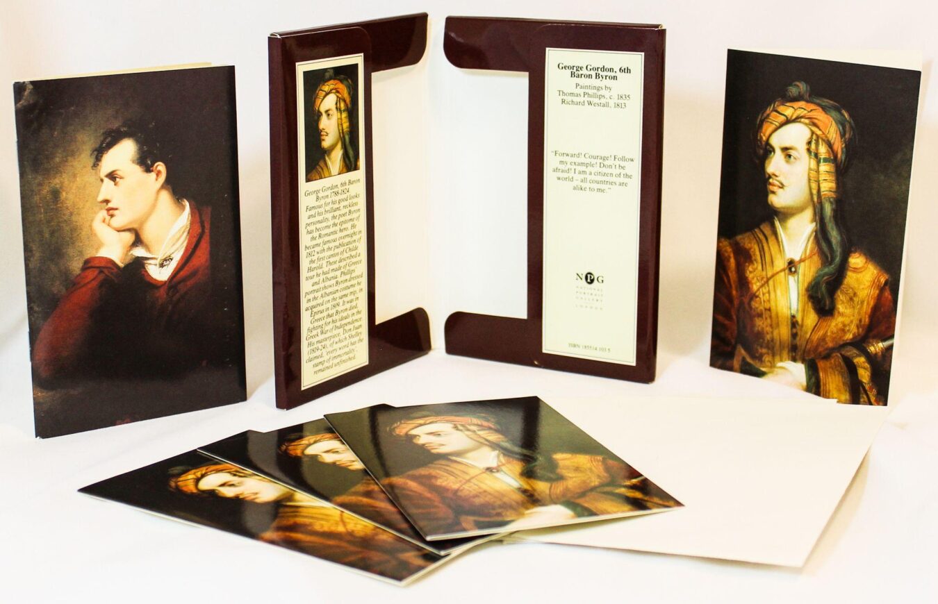 A stationery set featuring portraits of George Gordon, Lord Byron, including printed cards, envelopes, and a folder with biographical text and quotes from the poet.