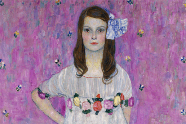 Detail of a portrait of a young girl standing confidently in a white ruffled dress decorated with colorful flowers, set against a bright pink patterned background. Painted in an expressive, textured style by Gustav Klimt.