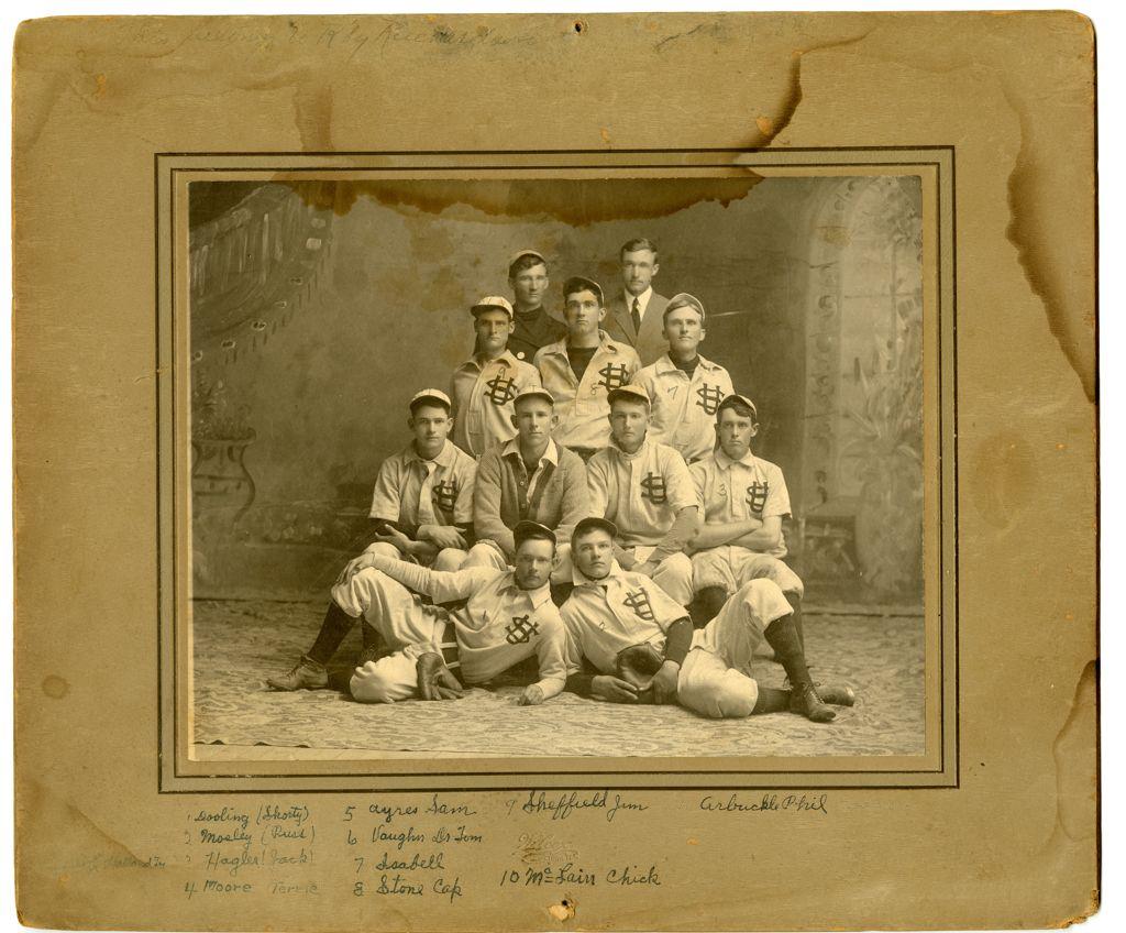 Vintage team photo of Southwestern University baseball players in uniforms with interlocking “SU” letters, seated in rows with their coach.