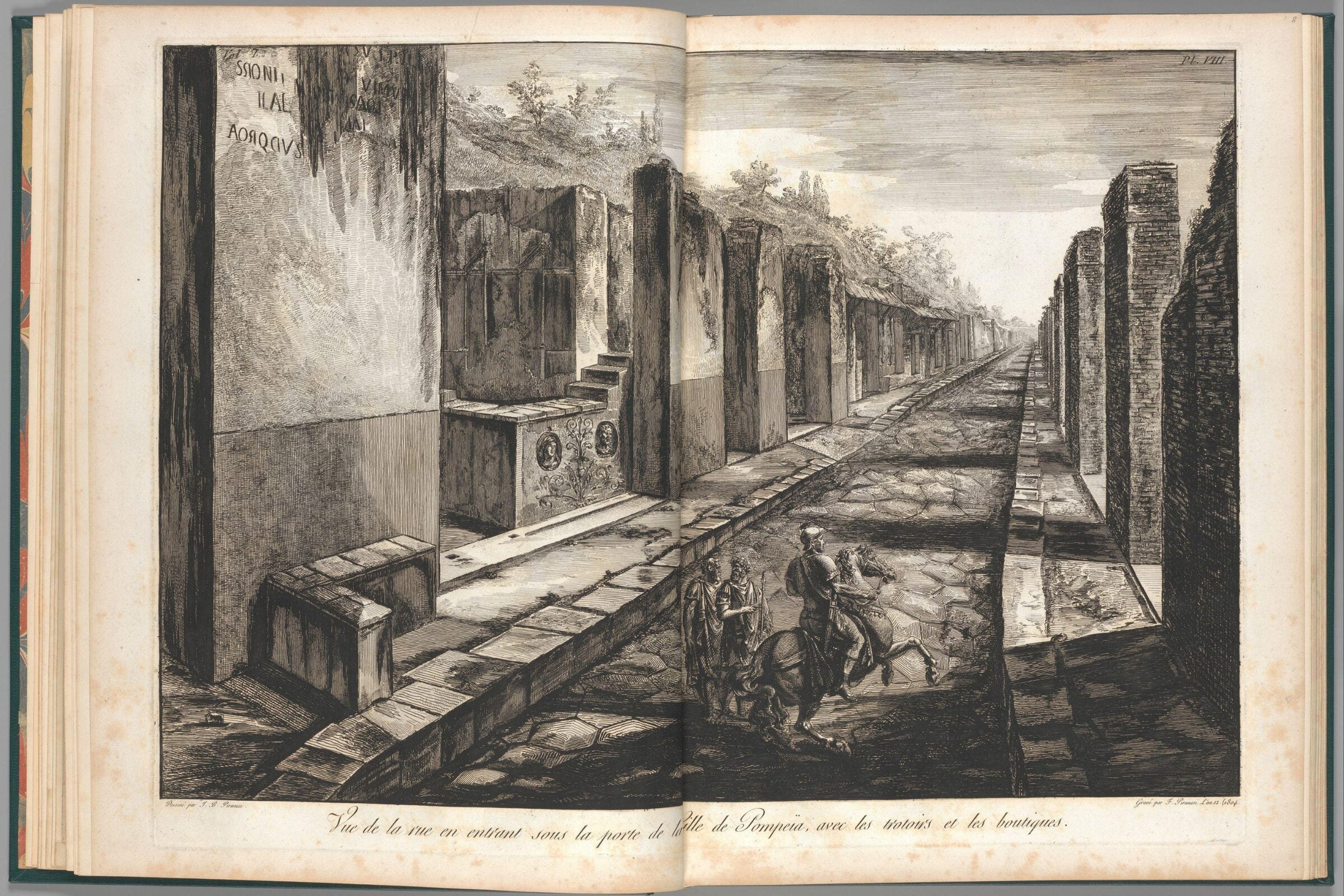 Engraving of a long, stone-paved street lined with ruins and walls in Pompeii, with a few figures on horseback and on foot in the foreground.
