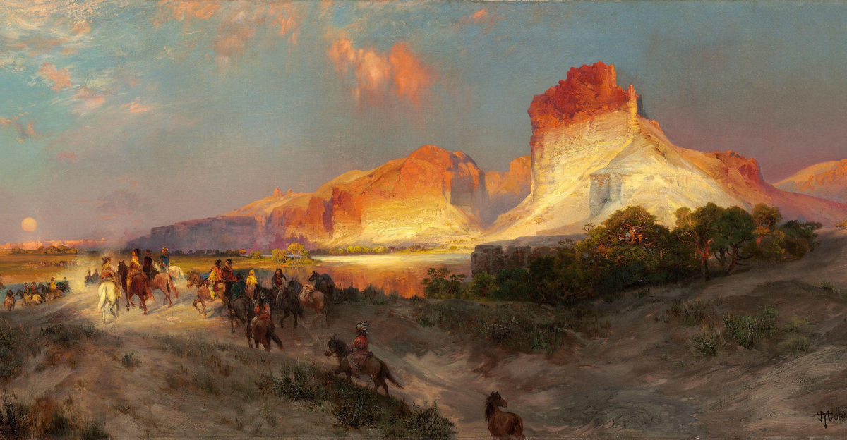 Riders on horseback pass glowing red and gold cliffs along Wyoming’s Green River at sunset.