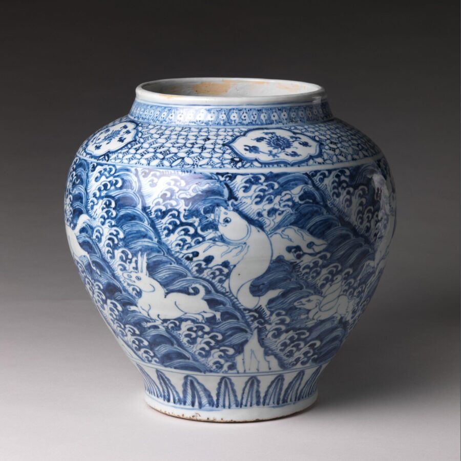 Blue and white porcelain jar decorated with mythical winged animals among waves, from 15th-century China.