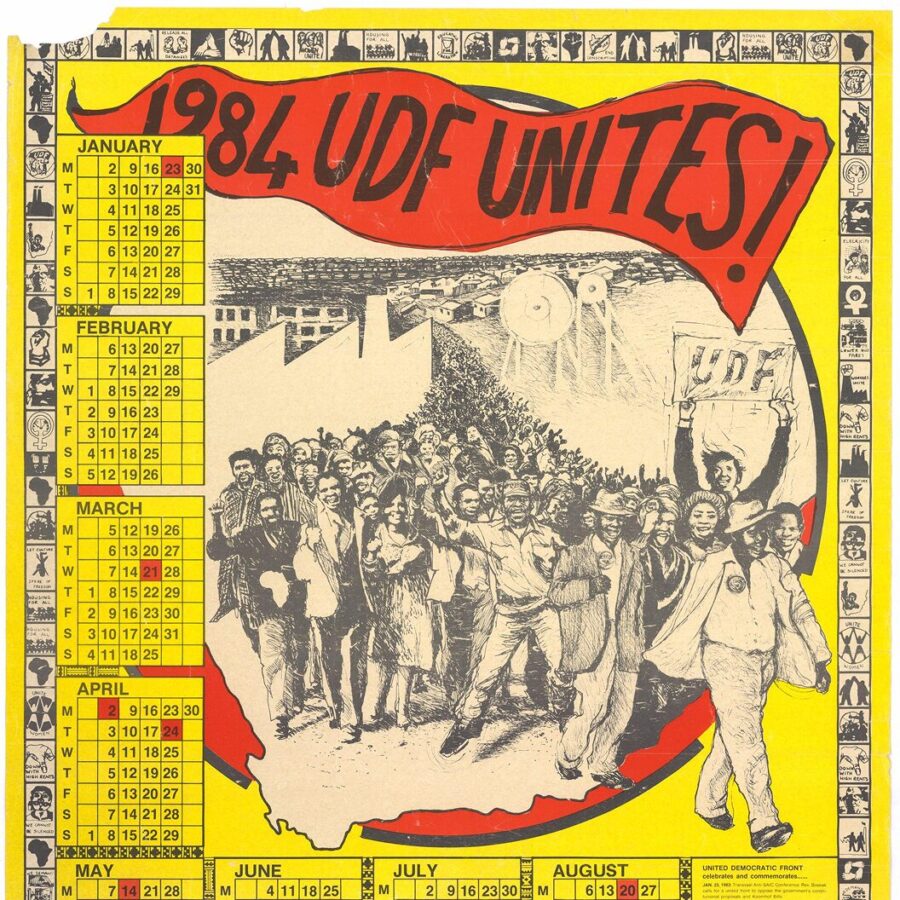 Colorful 1984 calendar poster titled “UDF Unites!” showing a large group of protesters marching together under a red banner, surrounded by calendar months and small symbolic illustrations.