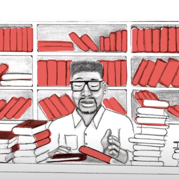 A hand-drawn illustration of a person with glasses sitting at a desk, surrounded by stacks of red books, with shelves of more red books behind them.