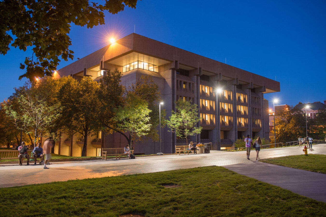 An academic library exterior at night.