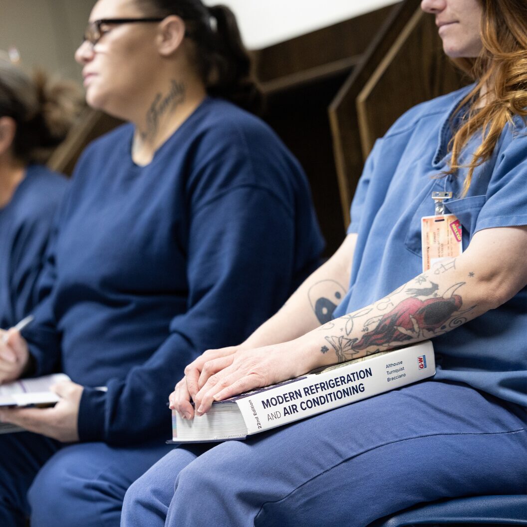 Incarcerated women who are participating in an air conditioning technology program taking a quiz in a classroom in a women’s correctional facility.