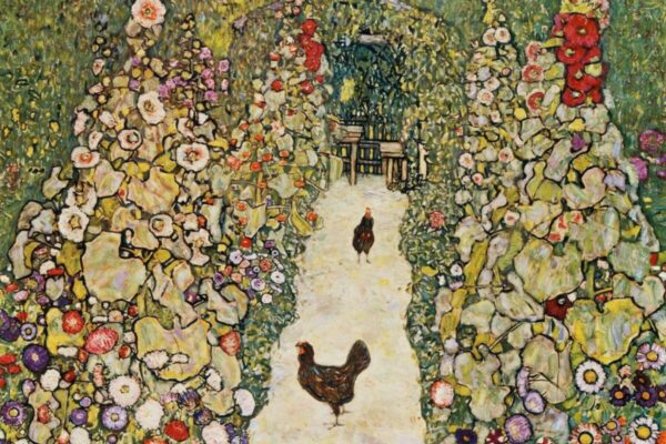 A lush garden path lined with tall, colorful flowering plants, with two hens walking along the light-colored walkway toward a shaded seating area in the background.