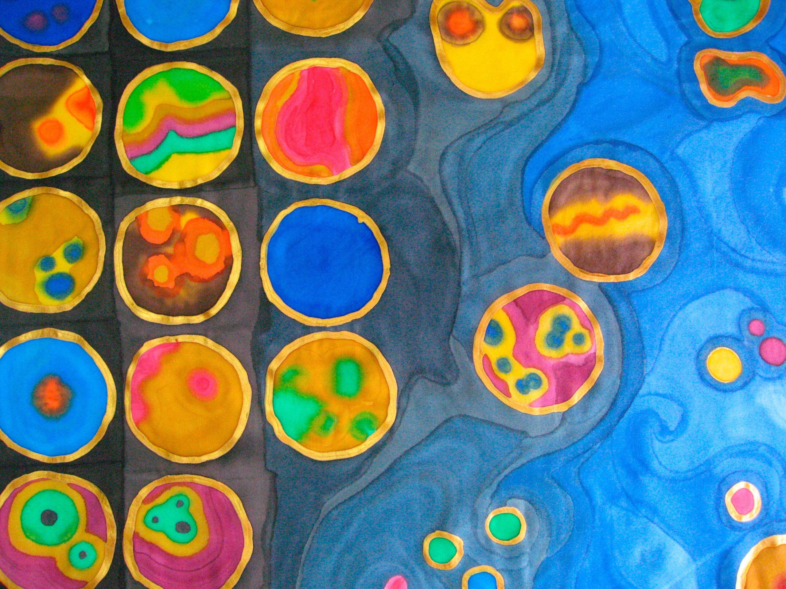 Colorful abstract artwork featuring rows of circular forms in bright blues, yellows, greens, and pinks on the left, blending into swirling blue shapes with scattered circles on the right, suggesting cells or microscopic life.