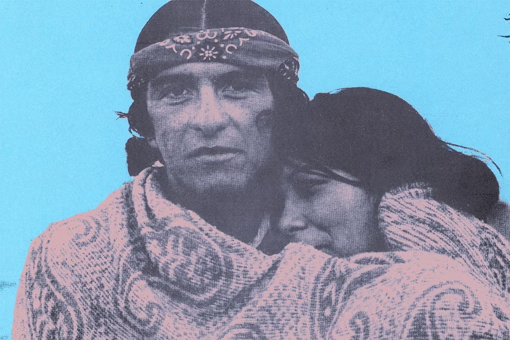 Halftone image of a Native American man wearing a bandana, holding a woman close against a bright blue background.