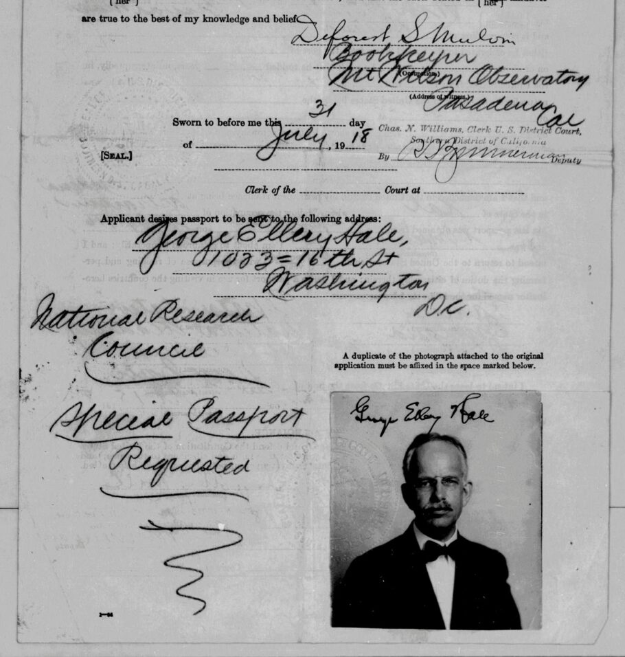 Black-and-white passport application form from 1918 with handwritten details, official stamps, and a small portrait photo of a middle-aged man wearing glasses and a mustache.