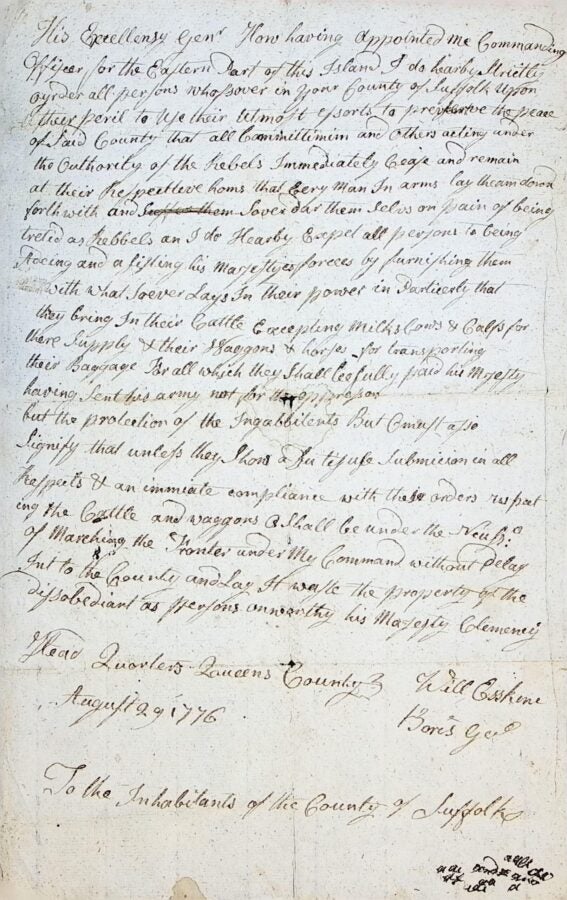 Photograph of a handwritten 18th-century proclamation on aged paper, dated August 29, 1776. The document begins “His Excellency Genl Howe…” and addresses “To the Inhabitants of the County of Suffolk,” written in dense cursive ink with visible creases and wear.