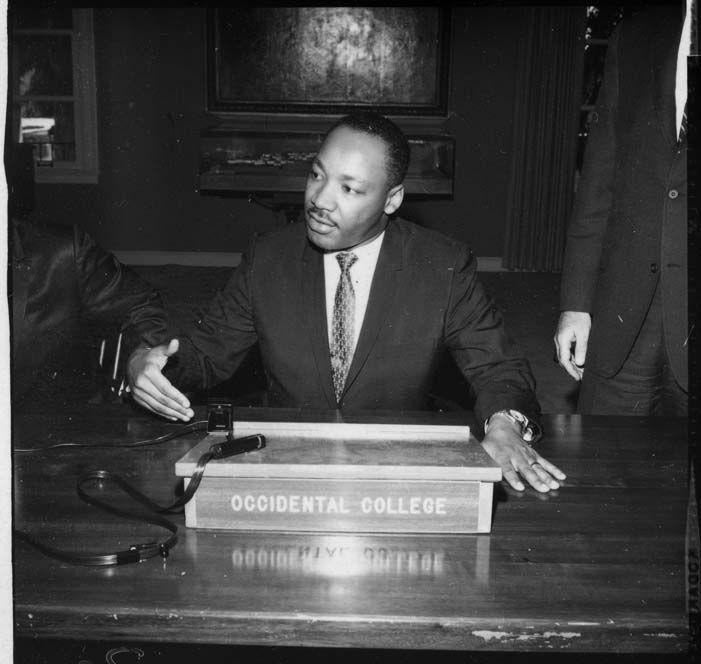 Black-and-white photograph of Martin Luther King Jr. speaking from a podium at Occidental College.