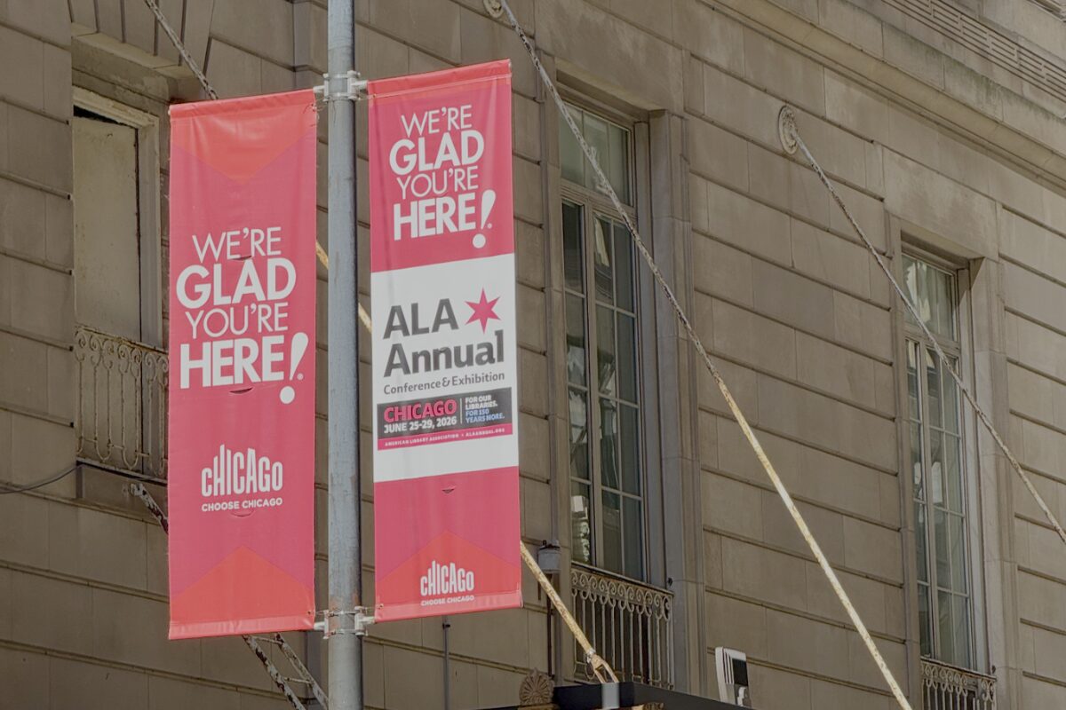 Pink street banners outside a Chicago building welcome attendees to the ALA Annual Conference & Exhibition.