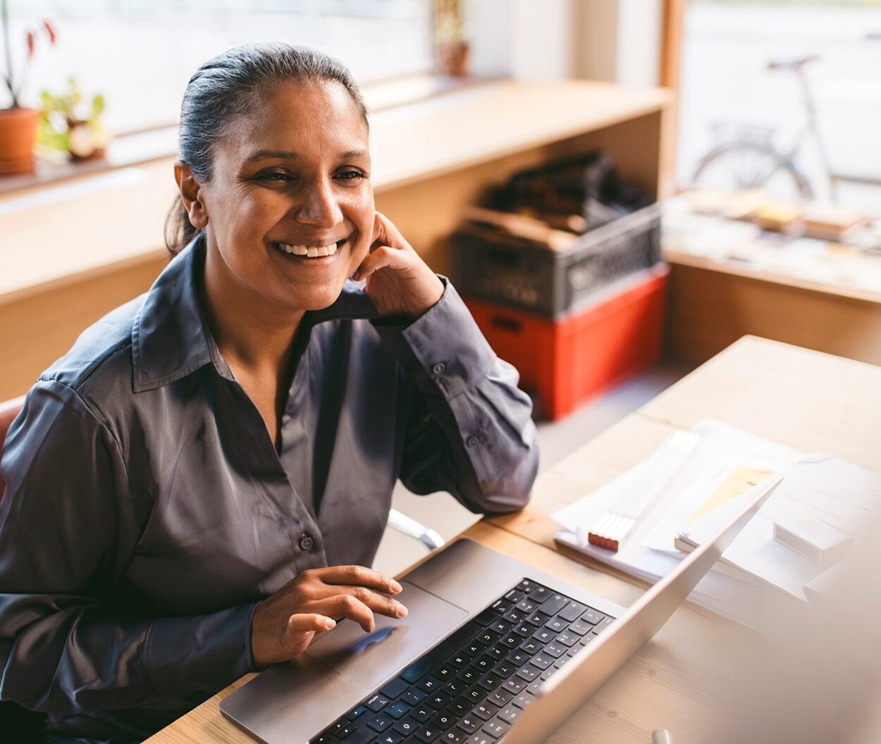 Researcher using a laptop, representing new readers who discovered Path to Open books after they became openly accessible.