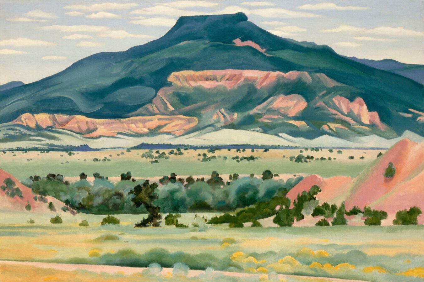 Oil painting of southwest landscape featuring a mesa, locally known as Pedernal, in the background depicted with a deep teal and pastels; vegetation depicted in hues of green in the foreground; and sky with fluffy clouds above.