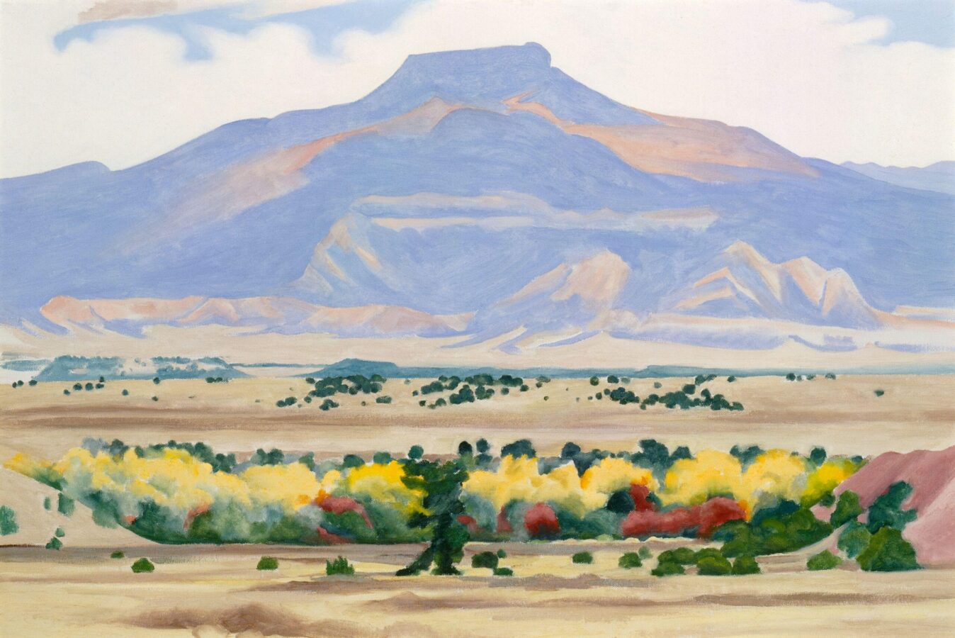 Oil painting of southwest landscape featuring a mesa, locally known as Pedernal, in the background depicted with light blue and soft pastels; green, yellow, and red vegetation in the foreground; and primarily white sky above.