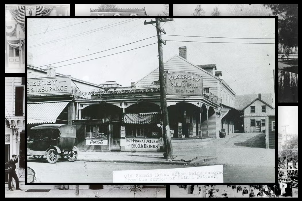 Black-and-white archival photograph of the old Samis Hotel on a street corner, surrounded by smaller historic photographs in a collage. The two-story wooden building features a wraparound porch, storefronts, and signs advertising Coca-Cola, hot frankfurters, and cold drinks. An early automobile is parked along the street, and a utility pole stands in the foreground.